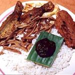 Nasi lemak is the trademark meal for Malays. Nasi means rice in Malay. Rice cooked in rich coconut milk is eaten with fried chicken, fried ikan bilis (anchovies), achar (a kind of seasoned vegetable salad), a fried egg and a dollop of spicy sambal chilli.