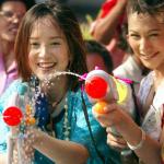 Two Thai woman play water battle during a parade to kick off the Songkran festival in Bangkok. Thailand's famed Songkran water festival commemorates the kingdom's traditional lunar new year.