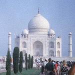 Agra, India. The Taj's bulbous dome, 58 feet in diameter, reaches a height of 187 feet, and can be seen well before one passes through the high wall girding the compound. The mausoleum rests on a 22-foot high plinth, on whose stones, much polished through years of traffic, visitors sit or play. At each corner stands a minaret topped by a kiosk.