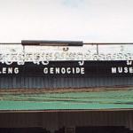 Phnom Penh, Cambodia. This forbidding metal sign marks the entryway to Tuol Sleng, which remains surrounded by high walls and barbed wire. Around the entryway mill Cambodia's beggars: Tuol Sleng is a main tourist attraction.